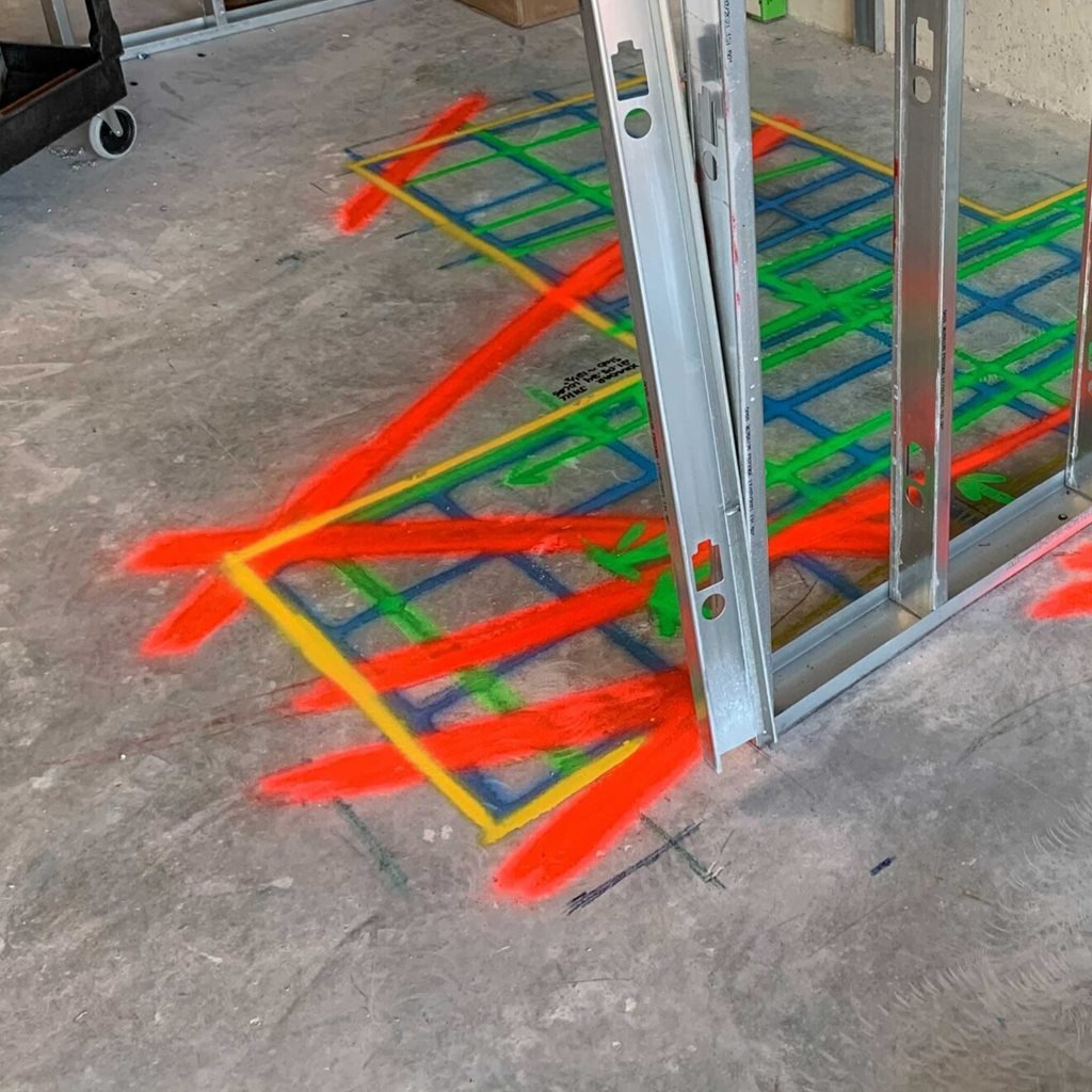 Scan area marked in yellow, green and blue with red lines across it, next to steel studs