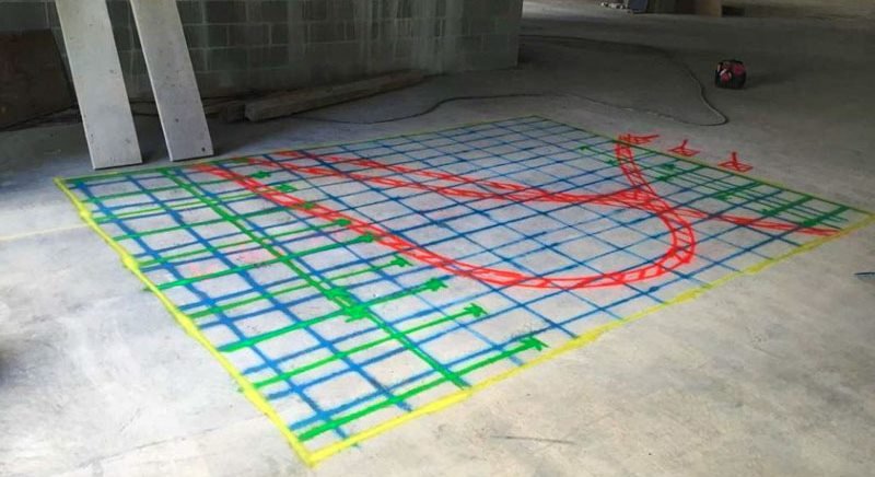 Full slab mark-out with blue and green grid lines and a curved red line inside a yellow border