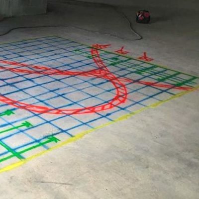 Blue and green scan grid with a curved red line marking a buried run