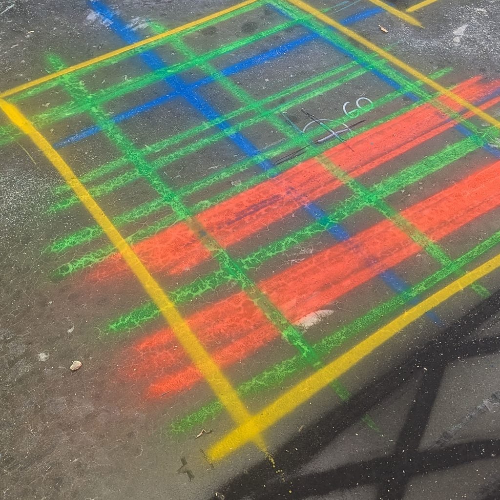 Close-up of green, blue and orange lines marked on concrete after a GPR scan