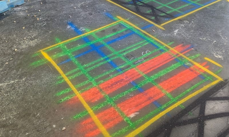 A full rebar and conduit grid marked out on a concrete floor after a GPR scan
